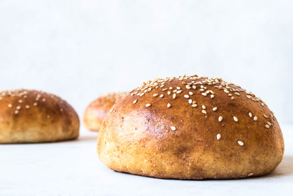 Hjemmelavede burgerboller - store burgerboller med smør og drysset med sesam - opskrift